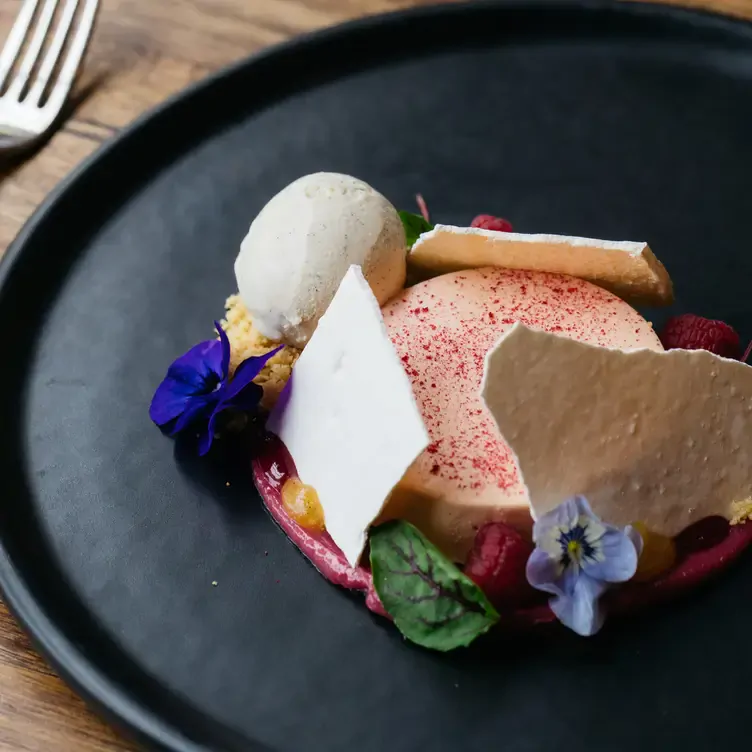 A pale pink dessert surrounded by white bark, flowers and a scoop of vanilla ice cream at Coombe Yarra Valley.