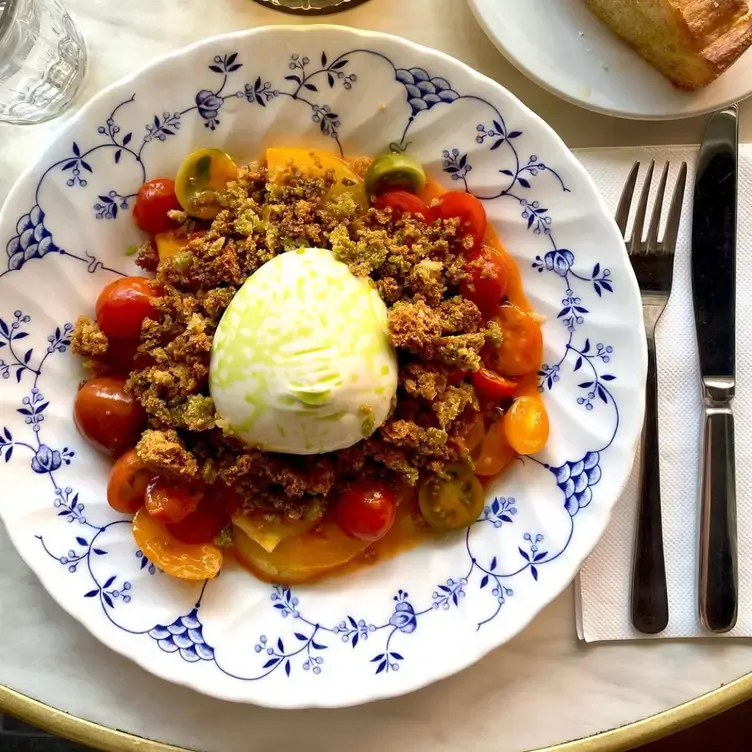 A dish with tomatoes and cheese served at Chester White Cured Diner.