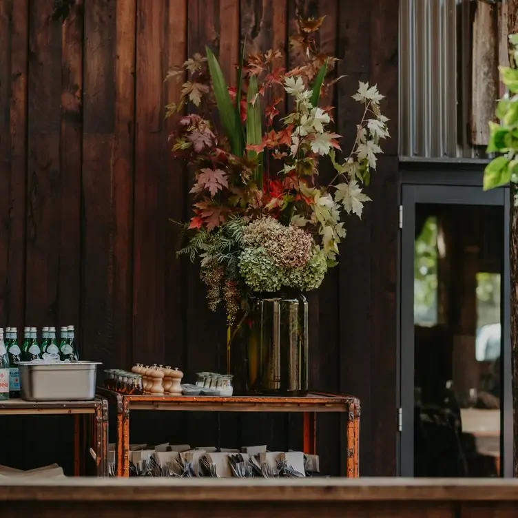 A bouquet of flowers alongside bottles of water at T’Gallant Vineyard, one of the best wineries in Victoria.