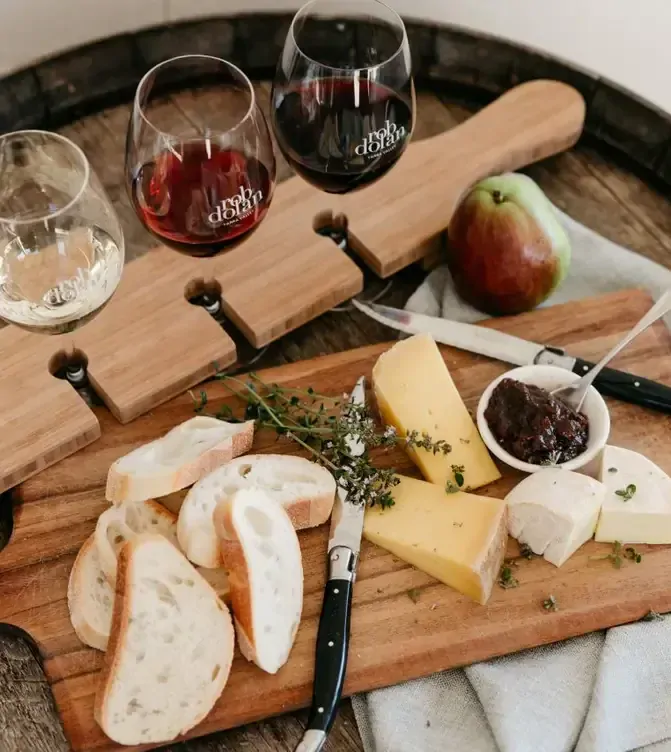 A flight of three different wines served alongside a board of bread, cheese and jam at Rob Dolan Wines, one of the best winery restaurants in Victoria.