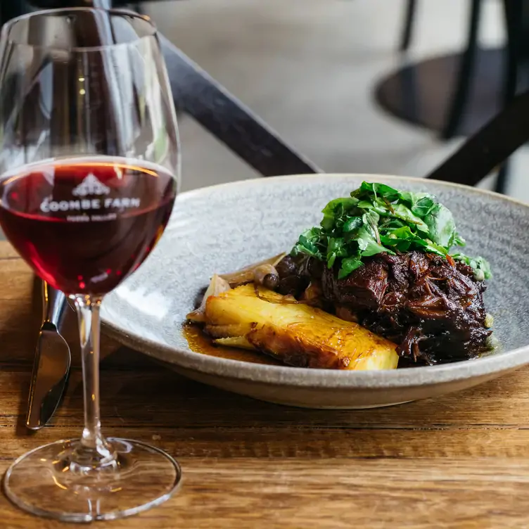 A glass of wine and a red meat dish served at Coombe Yarra Valley, one of the best winery restaurants in Victoria.