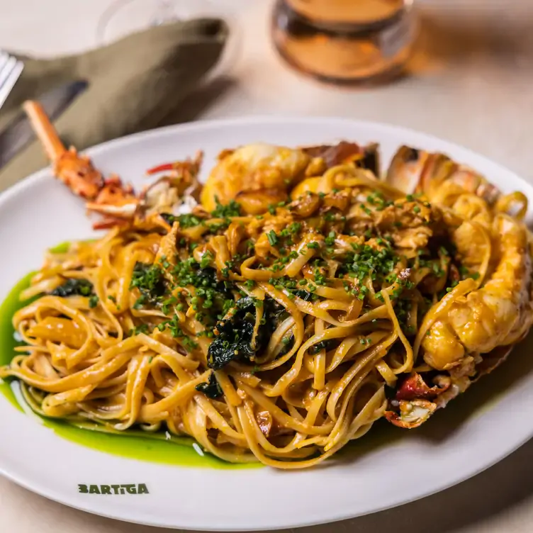 A noodle dish topped with herbs served at Bartiga, one of Sydney’s best new restaurants.