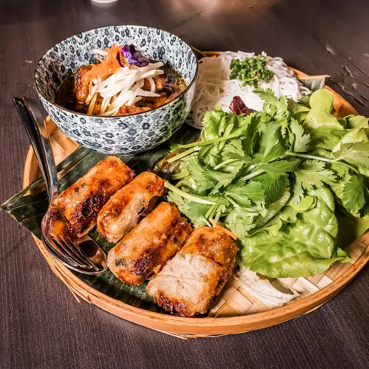 A dish with fried rolls, salad and noodles served at District1 Modern Vietnamese Eatery, one of the best Asian restaurants in Adelaide.