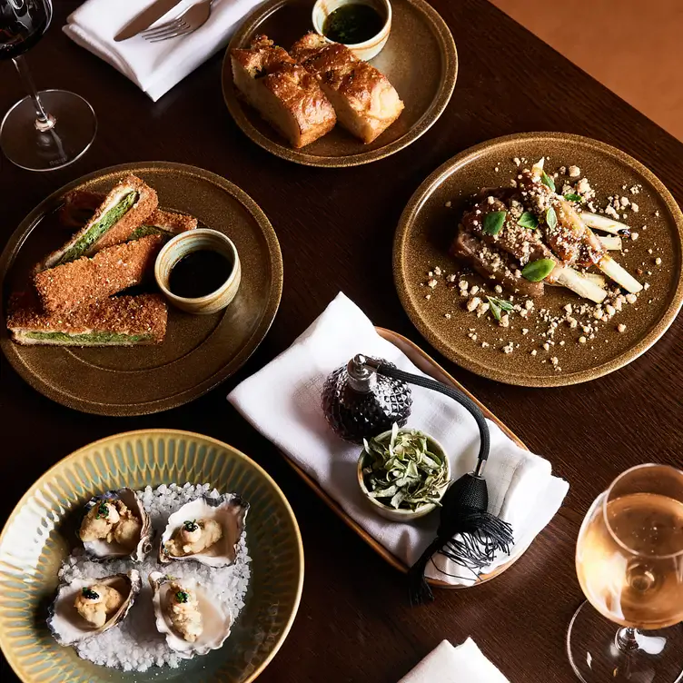 A table laid with oysters, bread and other dishes at Colt Dining, one of Melbourne’s best new restaurants.