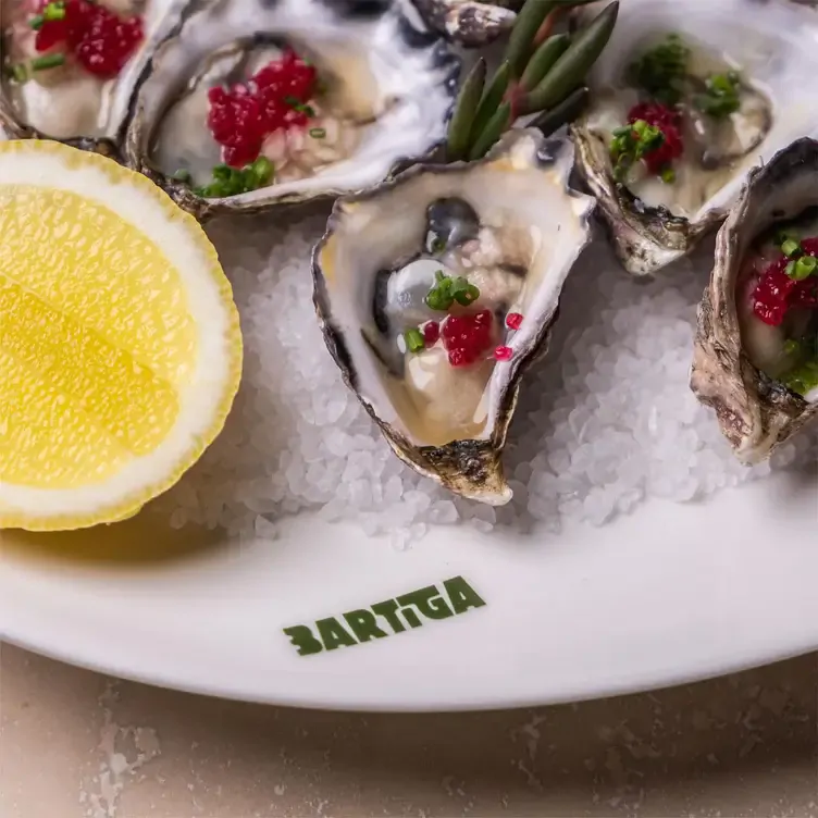 Oysters served alongside roe on a bed of salt at Bartiga, one of the best new restaurants in Sydney in 2024.