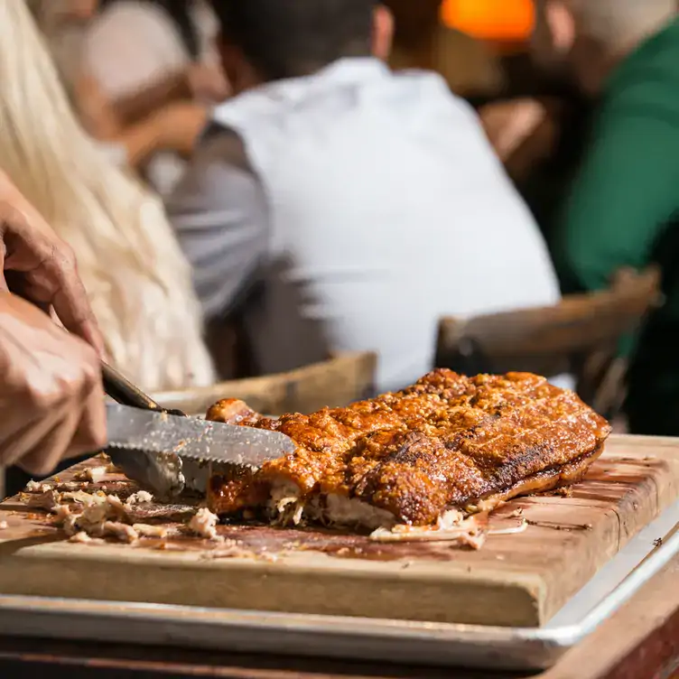 Someone carves meat at Braza Churrascaria - Darling Harbour, one of the best family restaurants in Sydney.