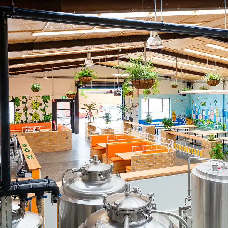 The colourful restaurant seating area next to the microbrewery at KAIJU! Beer & Pizza, one of the best family restaurants in Melbourne.