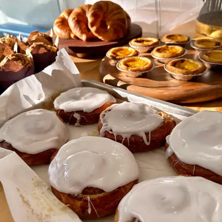 Trays of cakes and pastries including croissants, iced buns and small tarts served at Golly Gosh!, one of the best brunch spots in Brisbane.