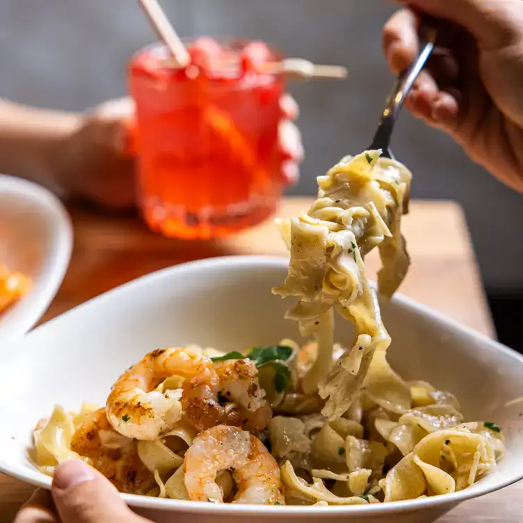 A diner twirls pasta around their fork at Vapiano - Soul Boardwalk.