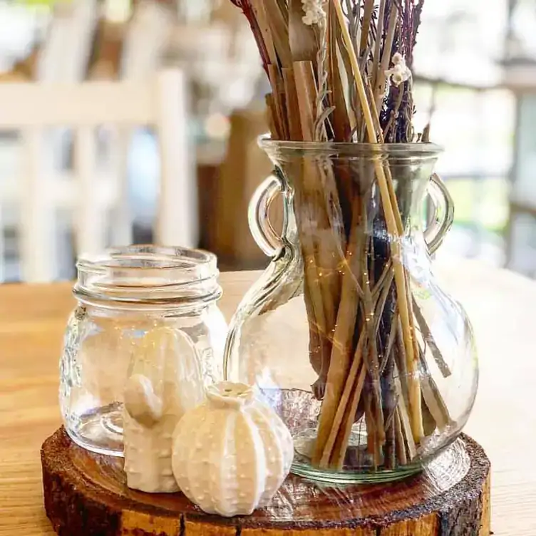 Salt and pepper shakers shaped as cactuses sit alongside a jug of dried flowers on the dining table at White Horse Ranch.