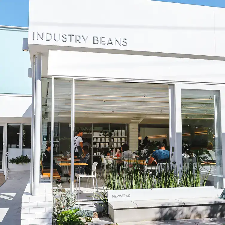 The exterior of Industry Beans Newstead, showing the main doors pulled open to reveal the spacious seating area indoors.