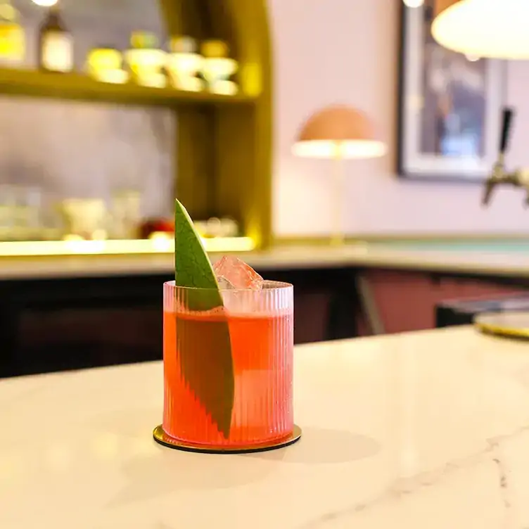 A watermelon cocktail with ice cubes and a watermelon wedge at Marilyn’s Bar and Diner.