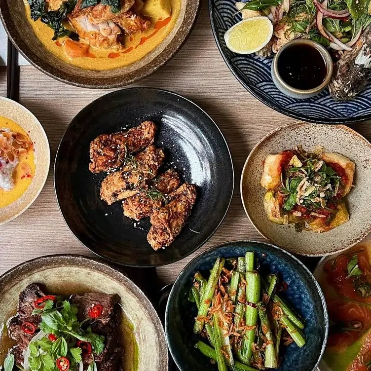 Plates of chicken, salad and more served at Noi Vietnamese Eatery, one of the best family restaurants in Adelaide.