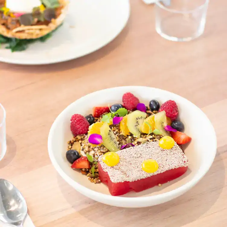 A dish served with berries and kiwi fruit at Industry Beans Newstead, one of the best places for brunch in Brisbane.