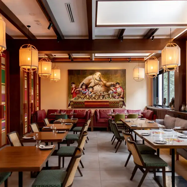 The interior of Jumbo Thai Restaurant & Bar, showing the tables, couch seating and a large painting on the back wall.