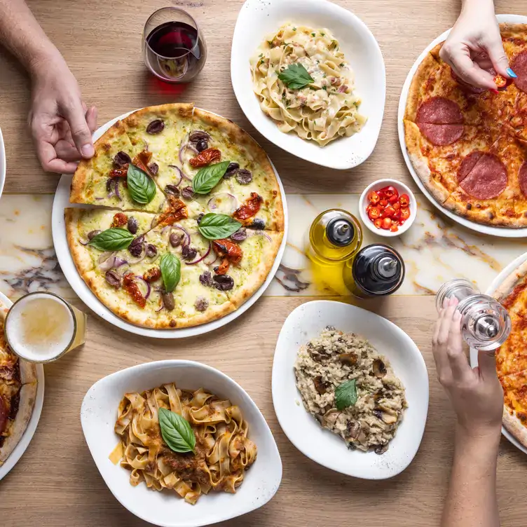 Large pizzas and bowls of pasta served at Vapiano - Soul Boardwalk, one of the best family restaurants on the Gold Coast.