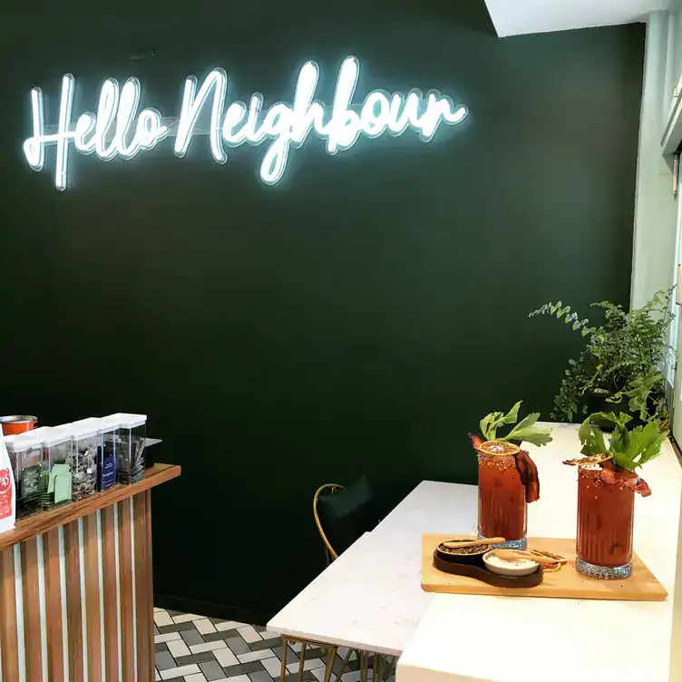 The neon sign at Hello Neighbour Artusi by Night, one of the best brunch spots in Adelaide.