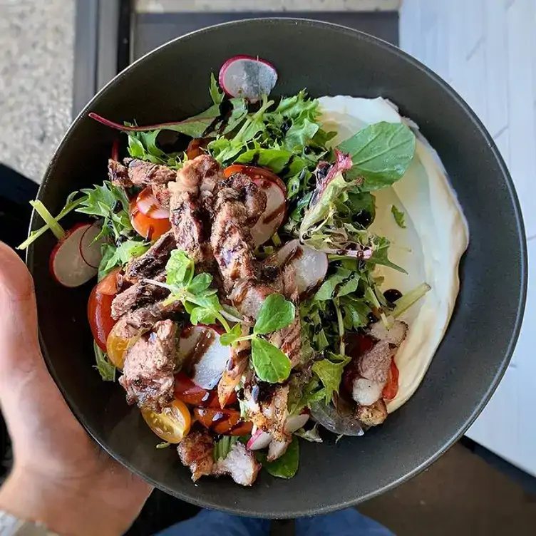 A bowl of salad, red meat and yoghurt served at JIBBI & CO, one of Adelaide’s best brunch spots.