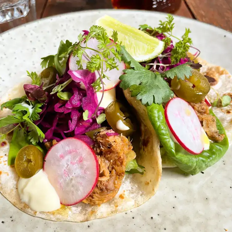 Tacos garnished with herbs, pickles and radishes at Tamborine Mountain Coffee Plantation.