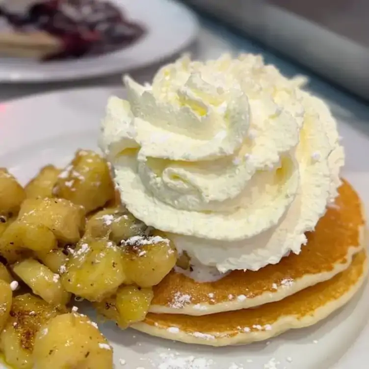 Pancakes with stewed apple and whipped cream at Pancake Diner Coolangatta, one of the best brunches on the Gold Coast.