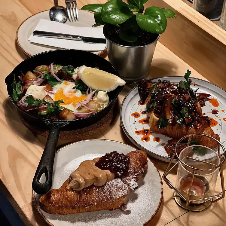 A table laid with two croissants with sweet and savoury fillings served at 34 WYATT STREET, one of the best brunch spots in Adelaide.