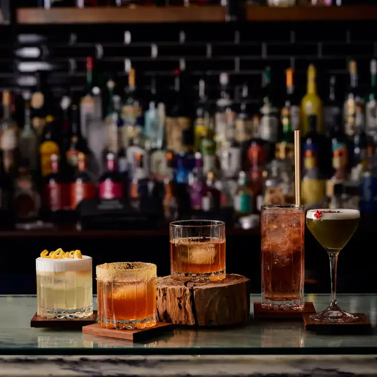 Five different cocktails sit on the bar at Hardy’s Verandah Restaurant, one of the best warm and cosy restaurants in SA.