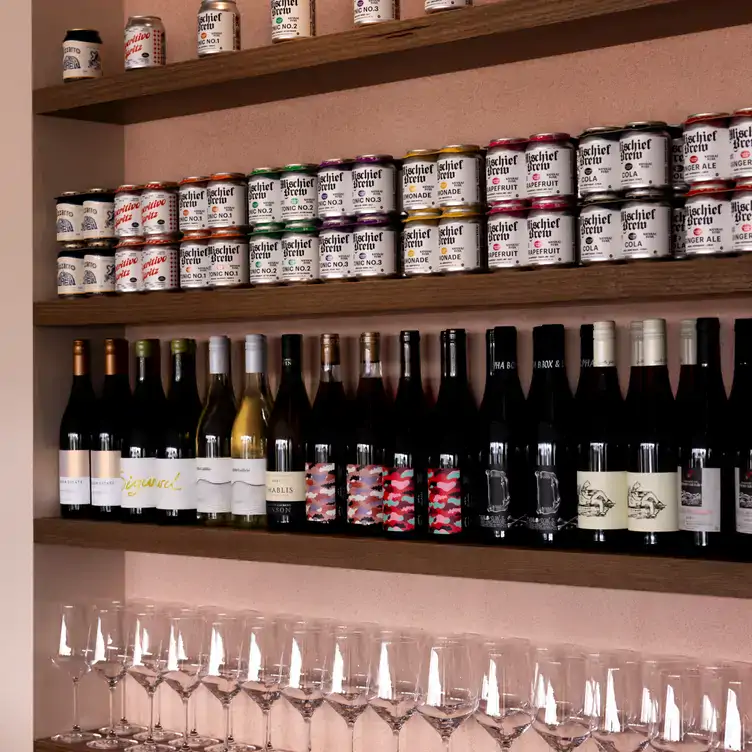 Shelves of wine bottles and cans of beer served at Yellow Matter Brewing, one of the best bars in Adelaide.