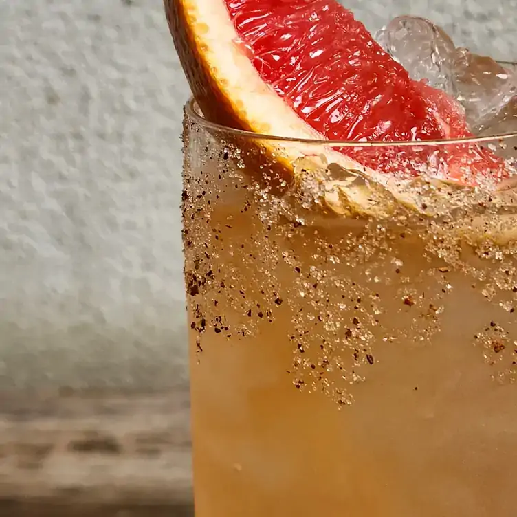 A cocktail garnished with a slice of citrus fruit served at Udaberri Pintos Y Vino, one of the best bars in Adelaide.