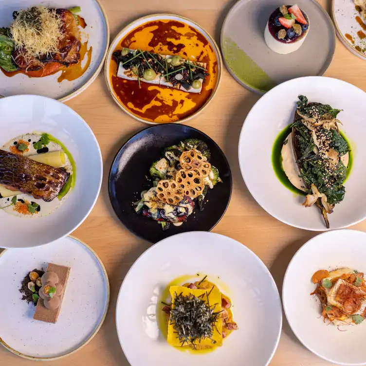 A table laid with different dishes including desserts, salads and seafood at Koomo Restaurant and Bar, one of the best bars in Adelaide.