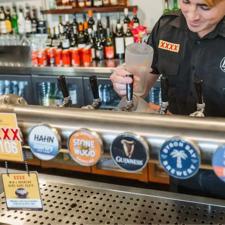 A bartender pours a pint of beer at Rocklea Hotel, one of Brisbane’s best pubs.