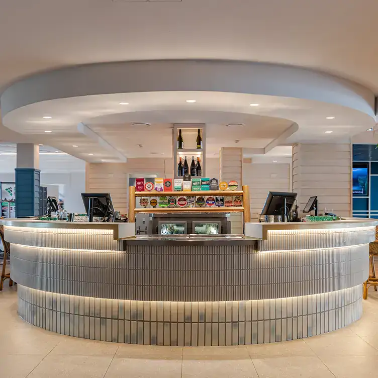 The central, round, white-tiled bar at the Full Moon Hotel, one of the best pubs in Brisbane.