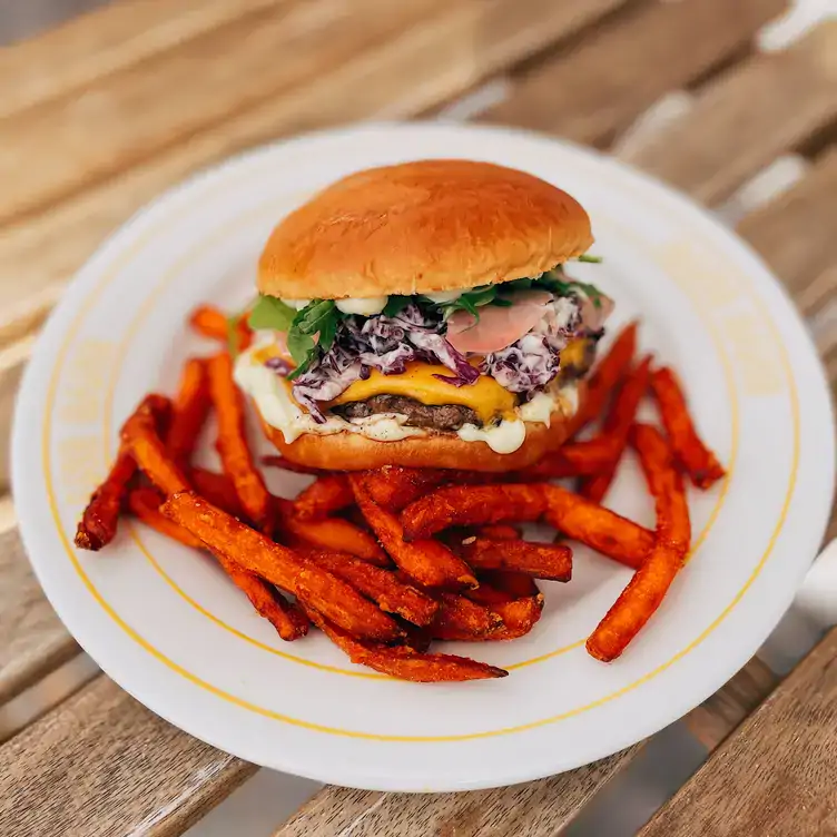 A loaded burger served with fries at GANG GANG Parkside, one of the best pubs in Adelaide.