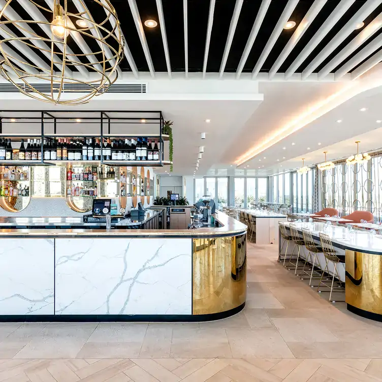 The white marble and gold central bar at Storehouse Subiaco, one of the best bars in Perth.