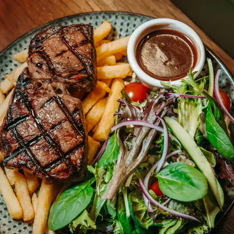 A plate of steak, chips, salad and sauce served at Rocklea Hotel, one of the best pub lunches in Brisbane.