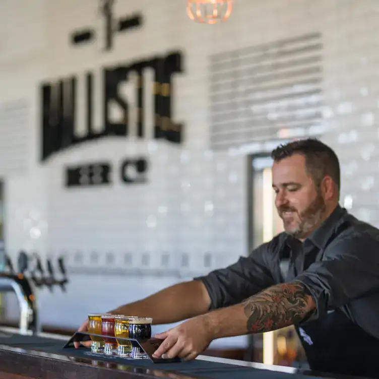 Someone serves up a flight of different beers at the bar at Ballistic Beer, one of the best pubs in Brisbane.