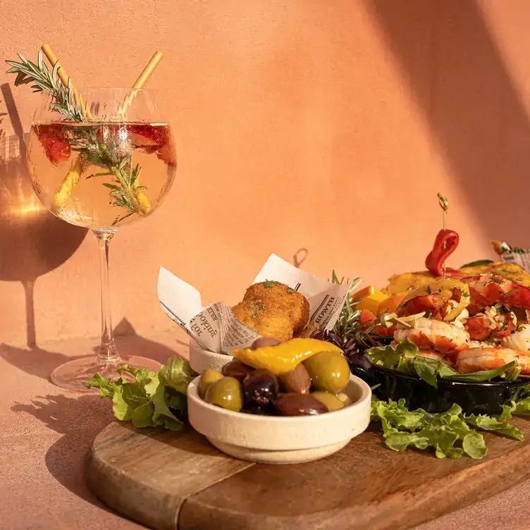 A board with a bowl of olives, prawns and salad served at Lucia, one of the Gold Coast’s best restaurants.