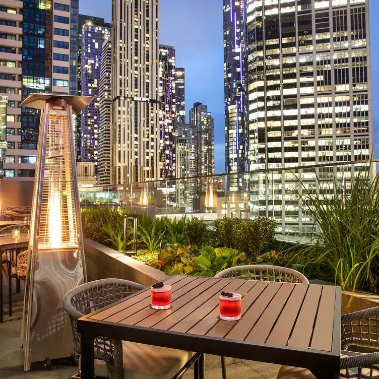 A view over the Melbourne city skyline at night, from the rooftop at Blacksmith Bar and Grill, one of the best rooftop restaurants in Melbourne.