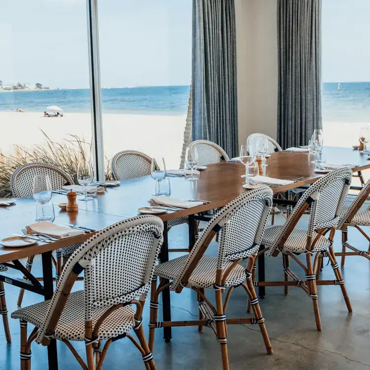 A dining table with views over the beach at Elwood Bathers